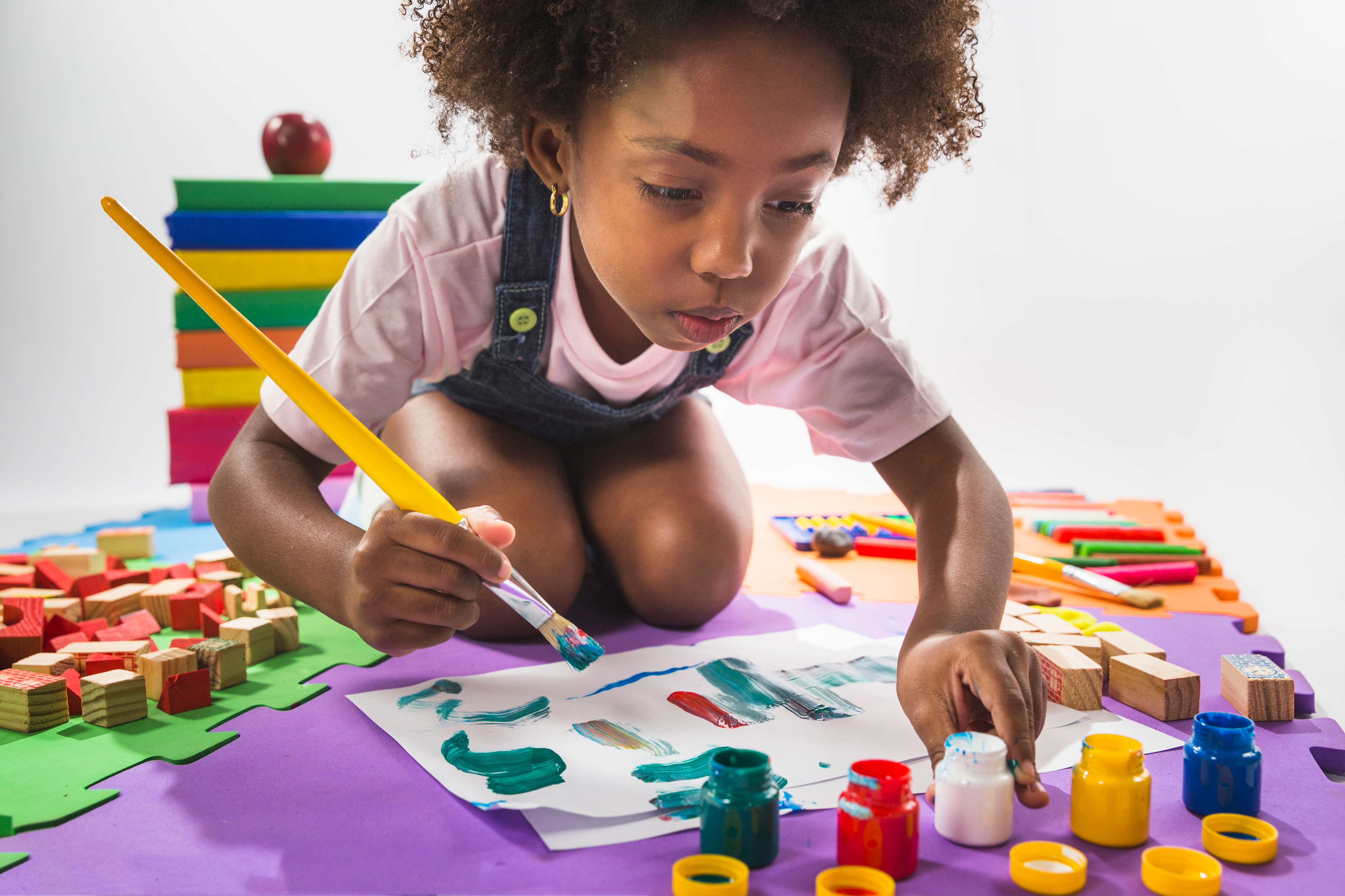 Child focused on painting activity